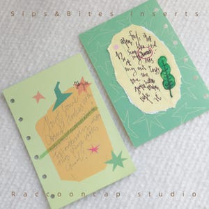 May include: Two planner inserts with handwritten notes and decorative elements. One insert is light green with a pumpkin illustration and text. The other is green with star patterns and a torn paper with text and a green leaf illustration. The text "Sips & Bites inserts" is at the top.