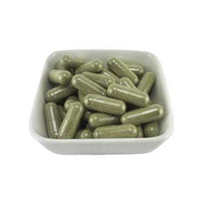 May include: A white ceramic dish filled with green herbal capsules.