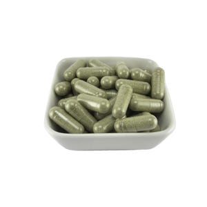 May include: A white ceramic dish filled with green herbal capsules.