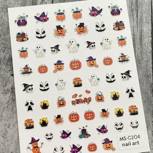 May include: A sheet of Halloween-themed nail art stickers. The stickers feature various designs, including pumpkins, ghosts, witch hats, and cauldrons. The word "HALLOWEEN" is also displayed. The sheet is labeled "MS-C204 nail art".