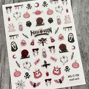 May include: Sheet of Halloween-themed nail art stickers. Designs include pumpkins, ghosts, bats, skulls, haunted houses, and the words "Happy Halloween" and "Spooky". The stickers are in shades of pink, black, and white. The sheet is labeled "MS-C198 nail art".