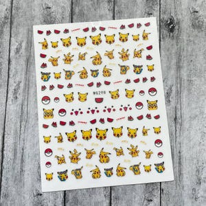 May include: A sheet of clear nail stickers featuring a variety of yellow Pikachu designs. The stickers depict Pikachu with different expressions, wearing sunglasses, and holding watermelon slices. The sheet also includes red watermelon slices and Poke Balls. The sheet is labelled "WG298".