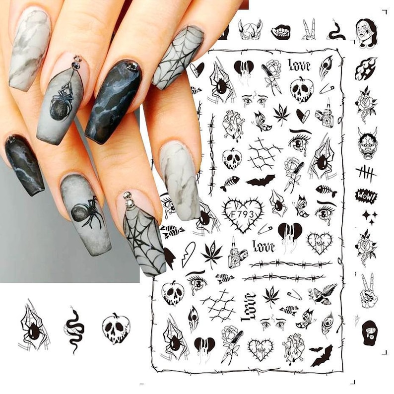 May include: Black and white nail art stickers with various designs including hearts, skulls, spiders, eyes, and the word "love".