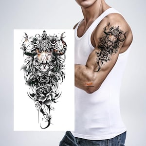 May include: A temporary tattoo featuring a detailed illustration of a bull with a lion's mane, horns, and floral accents. The design is predominantly black and white with touches of color, suitable for body art enthusiasts.