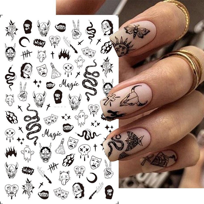 May include: Black and white nail art stickers with various designs including snakes, skulls, crosses, and the word "Magic".