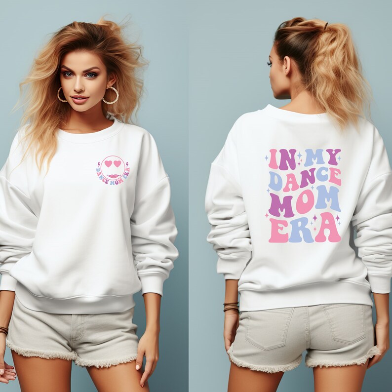May include: White sweatshirt with a pink and blue graphic on the front that says "Dance Mom Era" and a pink, blue, and purple graphic on the back that says "In My Dance Mom Era".