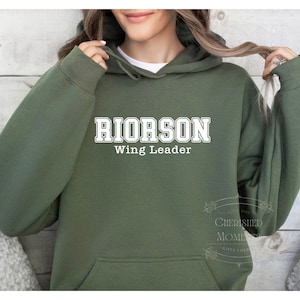 May include: A green hooded sweatshirt with the text "RIORSON Wing Leader" in white.