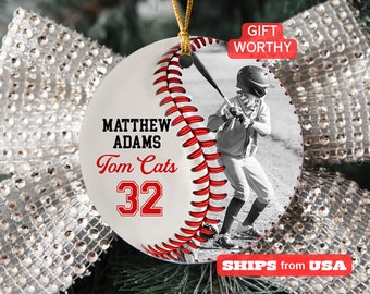 May include: A white baseball ornament with red stitching and a black and white photo of a baseball player. The ornament has the text "MATTHEW ADAMS Tom Cats 32". The words "GIFT WORTHY" are in a red box.