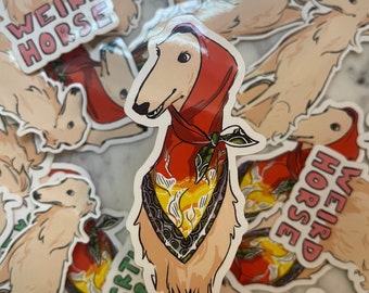 May include: A sticker featuring a cartoon illustration of a dog wearing a red bandana with a yellow and green floral pattern. The dog is wearing a red hood and has a white and tan coat. The sticker says "Weird Horse" in pink letters.