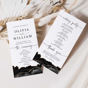 May include: Wedding ceremony programme cards with black and gold marble design. The cards feature the names Olivia and William, the date of the wedding, and a list of the ceremony events. The second card lists the wedding party members.