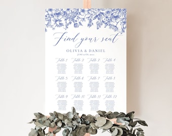 May include: A white wedding seating chart with blue floral illustrations at the top. The text "Find your seat" is in a cursive font. The names Olivia and Daniel are listed below the text, along with the date "June 22nd, 2023". The chart lists tables 1 through 12 with guest names.
