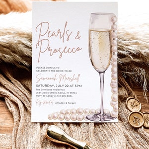 May include: A white invitation card with a watercolor illustration of a champagne flute and pearls. The text on the card reads "Pearls & Prosecco" and includes details for a bridal shower for Savannah Marshall.
