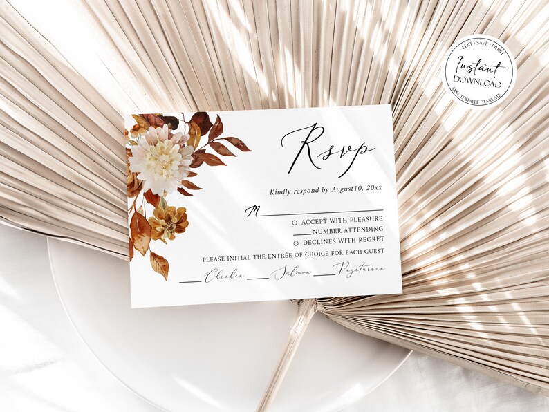 May include: A white RSVP card with a floral design featuring brown and white flowers. The card has a section for guests to indicate their attendance and meal choice. The text on the card reads "RSVP" and "Kindly respond by August 10, 20xx".