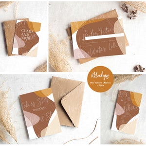 May include: Mockup of a wedding invitation suite with a brown, beige, and pink abstract design. The invitation includes the text "Clark and David" and "Water Lilies". The suite also includes a thank you card and a RSVP card.