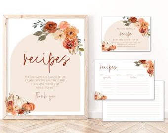May include: Printable recipe cards with a fall theme. The cards feature a watercolor design with pumpkins, leaves, and flowers in shades of orange, brown, and cream. The text on the cards reads "recipes" and "Please bring a recipe for the bride-to-be".