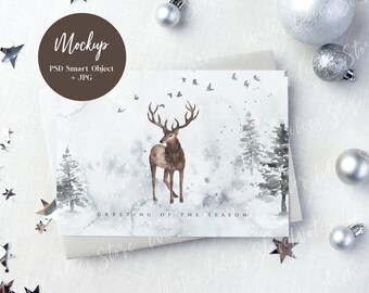 May include: A white card with a watercolor illustration of a deer in a snowy forest. The text "Greeting of the Season" is printed at the bottom of the card.