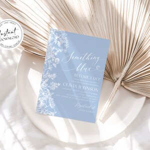 May include: A light blue invitation card with white floral designs and the text "Something blue" and "Before I Do!"  The invitation is for a bridal shower for Olivia Johnson.