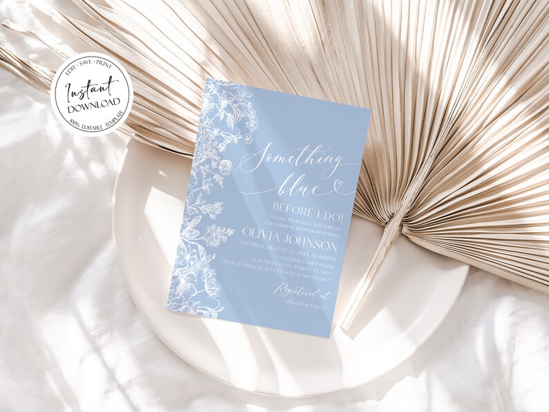 May include: A light blue invitation card with white floral designs and the text "Something blue" and "Before I Do!"  The invitation is for a bridal shower for Olivia Johnson.