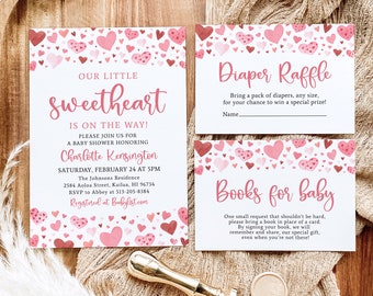 May include: Pink and white baby shower invitation with a watercolour heart pattern. The invitation says "Our Little Sweetheart is on the way!" and includes details for a baby shower honouring Charlotte Kensington. There are also two cards for a diaper raffle and a request for books for the baby.