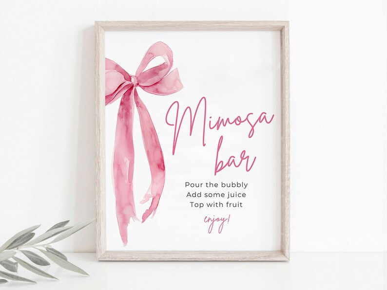 May include: A printable sign with a pink watercolor bow and the text "Mimosa Bar" in pink script. The sign also includes the instructions "Pour the bubbly, Add some juice, Top with fruit, enjoy!"
