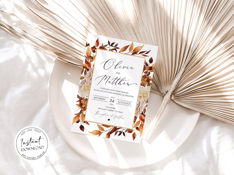 May include: A wedding invitation with a watercolor design featuring fall leaves in shades of orange, brown, and red. The invitation is for Olivia and Matthew, and it states the date and time of the wedding ceremony and reception. The text reads "Olivia and Matthew, Together with their families invite you to their wedding celebration, Saturday, July 24, 20xx, 1:00 o'clock, Villa Rome, 28 Alley Aubrey, TX 78257, Reception to follow."