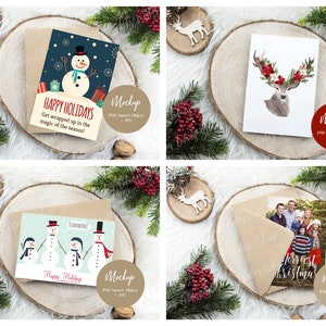 May include: Four Christmas card mockups with different designs. The cards are on a wooden slice with a brown envelope and a small wooden reindeer ornament. The designs include a snowman, a deer with red flowers, a group of snowmen, and a family photo.