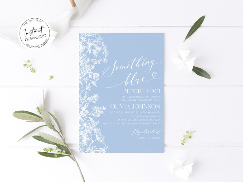 May include: A light blue bridal shower invitation with white floral illustrations and the text "Something blue" and "Before I do!"  The invitation includes the bride's name, the date and time of the shower, and the location. The invitation also includes the text "Registered at Amazon & Target".