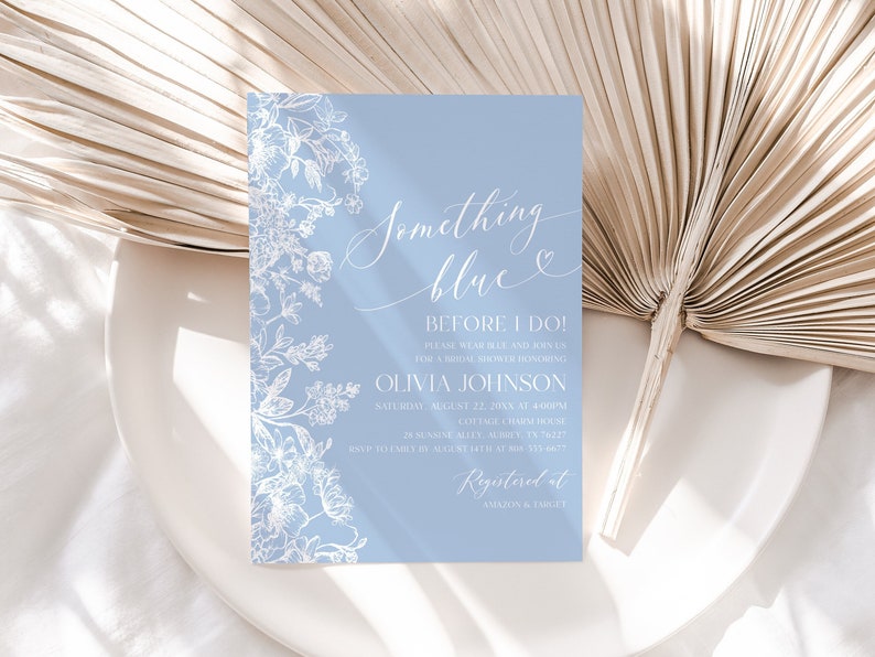 May include: A light blue invitation card with white floral designs and the text "Something blue" and "Before I Do!"  The invitation is for a bridal shower honoring Olivia Johnson on Saturday, August 22nd at 4:00 PM. The address is 28 Sunshine Alley, Hurley, TX 76227. RSVP to Emily by August 15th at 335-7777. The invitation also includes the text "Registered at Amazon & Emily".
