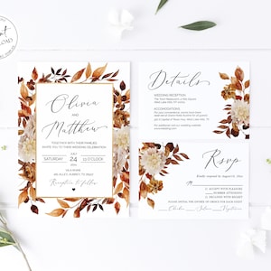 May include: Wedding invitation suite with a fall theme. The invitation features a gold frame with the names Olivia and Matthew, a date of July 24, 2023, and a time of 1:00 PM. The invitation is decorated with watercolor illustrations of fall leaves and flowers in shades of orange, brown, and white.