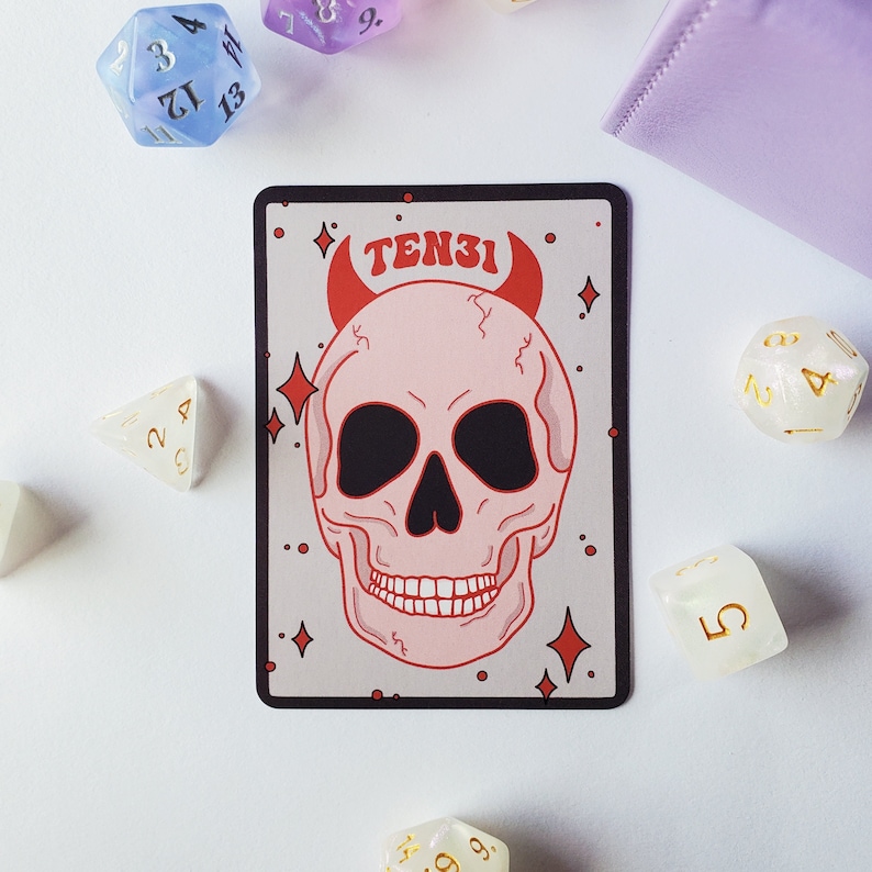 May include: A red and white skull with horns and the word "TEN31" above it. The skull is on a white background with gold stars.