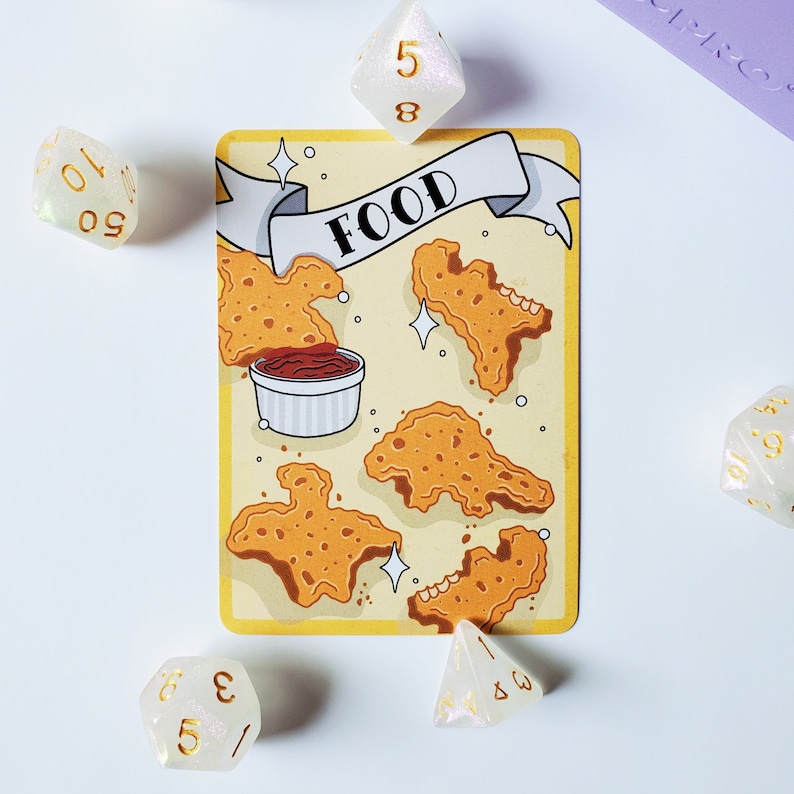 May include: A yellow card with a banner that says "FOOD" and a drawing of fried chicken pieces and a small bowl of dipping sauce. There are five white dice with gold numbers on them around the card.