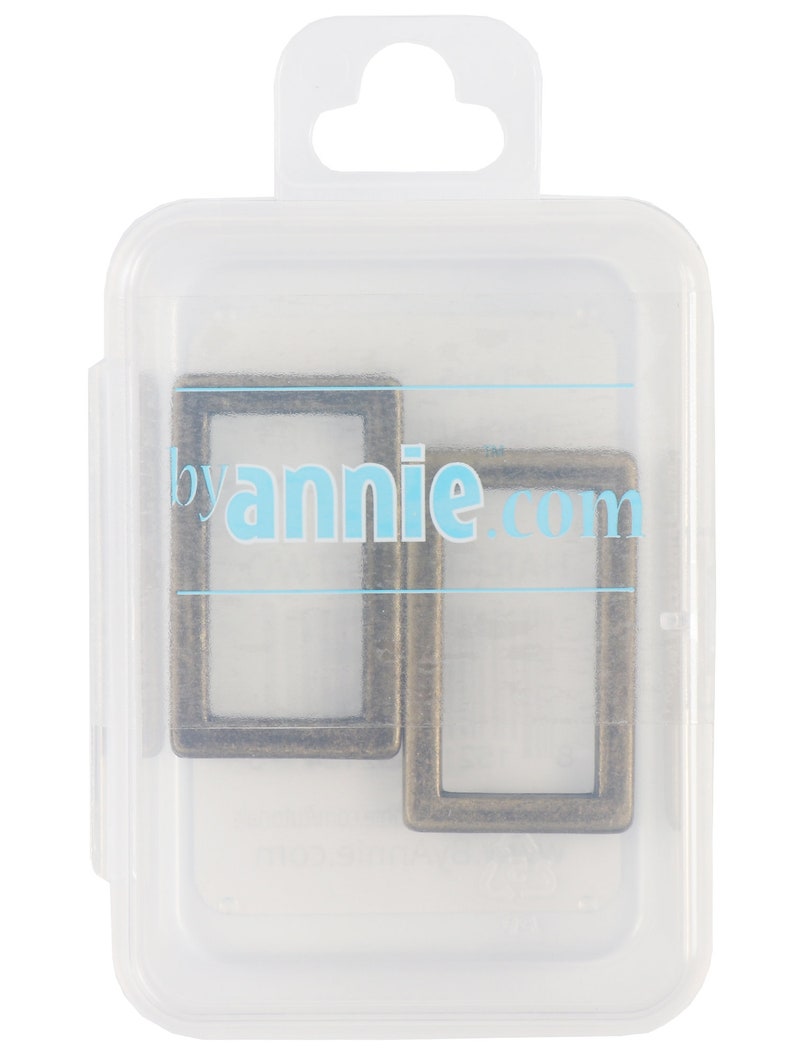 May include: Two antique bronze rectangular metal rings are displayed inside a clear plastic container. The container has a hanging tab at the top and the text "byannie.com" is visible on the container.