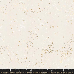 May include: White fabric with a scattered gold and white speckled pattern. The fabric is marked with a ruler in inches and the text "RUBY STAR SOCIETY".