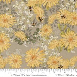 May include: A fabric print featuring yellow daisies and small white flowers on a taupe background with scattered bees and a faint hexagonal honeycomb pattern. A white ruler is visible at the bottom edge showing inches from 1 to 7.