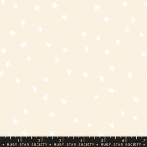 May include: Cream-colored fabric with a scattered pattern of white, hand-drawn stars. The fabric has a soft, neutral background, and the stars are irregularly shaped, creating a whimsical design. The bottom of the image has text that reads "RUBY STAR SOCIETY".