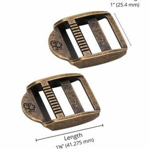 May include: Two antique brass-colored metal buckles. Each buckle has three rectangular openings and a central bar with ridges. The inside length is 1 inch (25.4 mm), and the length is 1 5/8 inches (41.275 mm).