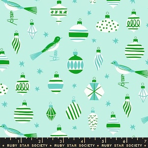 May include: A repeating pattern of Christmas ornaments and birds in shades of green, white, and teal on a light blue background. The ornaments have various designs, including stripes, dots, and geometric shapes. The birds are perched on springs.