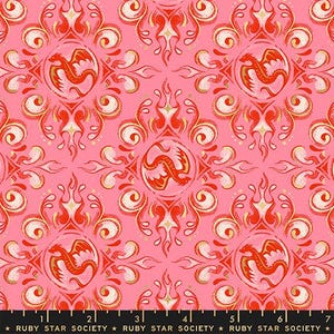 May include: A pink fabric featuring a repeating pattern of red and orange dragons enclosed in circular frames, surrounded by flame-like scrollwork. The bottom edge displays a black selvage with the text RUBY STAR SOCIETY.