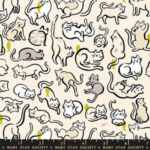May include: A cream-colored fabric featuring a repeating pattern of black-outlined cats in various poses, including sitting, stretching, and lying down, interspersed with small yellow fish icons. A black ruler with the text Ruby Star Society is visible.