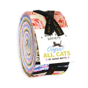 May include: A jelly roll fabric bundle featuring a variety of colorful patterns with cat motifs. The roll is secured with a black ribbon labeled Ruby Star Society and a white tag that reads Ruby Star Society Oops! ALL CATS BY SARAH WATTS.