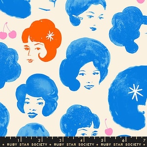 May include: A cream-colored fabric featuring a repeating pattern of stylized women's faces in blue and orange. Some faces have a flower or cherry accent. The text "RUBY STAR SOCIETY" is at the bottom.