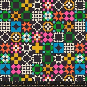 May include: A dark charcoal fabric featuring a repeating geometric pattern of squares, stars, and crosses in vibrant shades of pink, orange, yellow, green, and blue, with a ruler at the bottom edge labeled Ruby Star Society.