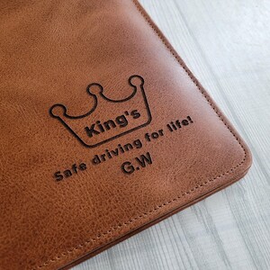 May include: Brown leather notebook with a crown and the text "King's Safe driving for life! G.W."
