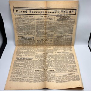 May include: A vintage newspaper with text in Russian, featuring the headline "Iosif Vissarionovich Stalin." The paper is yellowed with age and has multiple columns of text. The headline is in bold, black letters.