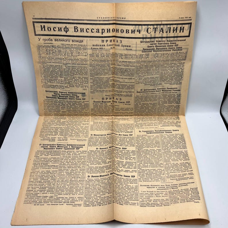 May include: A vintage newspaper with text in Russian, featuring the headline "Iosif Vissarionovich Stalin." The paper is yellowed with age and has multiple columns of text. The headline is in bold, black letters.