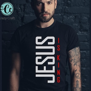 May include: A black t-shirt with white text that reads "JESUS IS KING" in a vertical, blocky font.