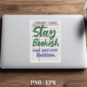 May include: A white laptop with a sticker that reads "Stay Bookish" in green and blue text, resembling a library card. A white mug with a black logo and coffee sits to the right. The background is a wooden surface.