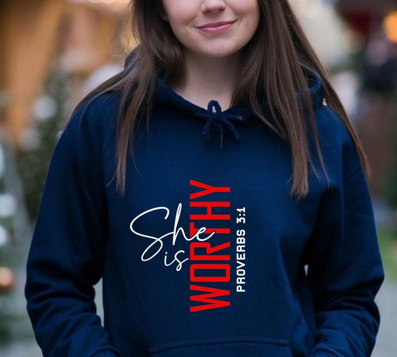May include: A navy blue hoodie with a white and red graphic that says "She is Worthy" and "Proverbs 3:1".