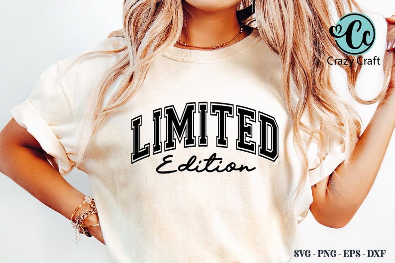 May include: Cream-colored t-shirt with the words "LIMITED Edition" in black, outlined in white, in a collegiate font. The text is centered on the shirt. The shirt has rolled-up sleeves.