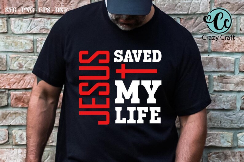 May include: A black t-shirt with the words "JESUS SAVED MY LIFE" in white and red lettering. A red cross is between the words "SAVED" and "MY".